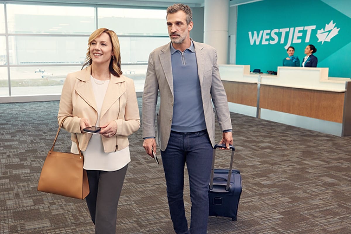 westjet-couple-at-airport-traveling-with-companion-voucher