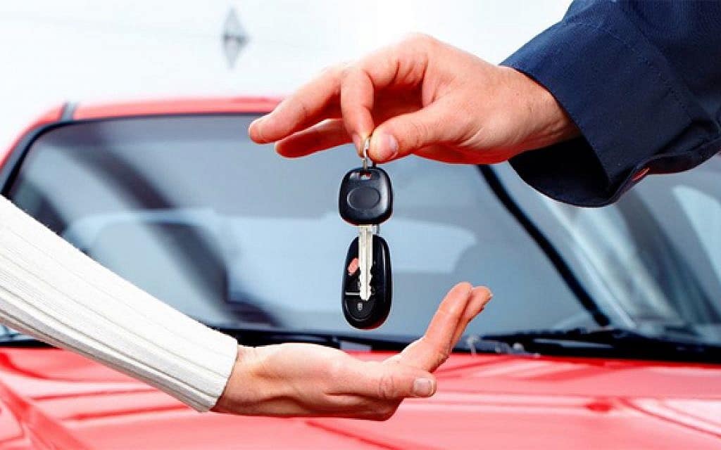Car rental keys changing hands.
