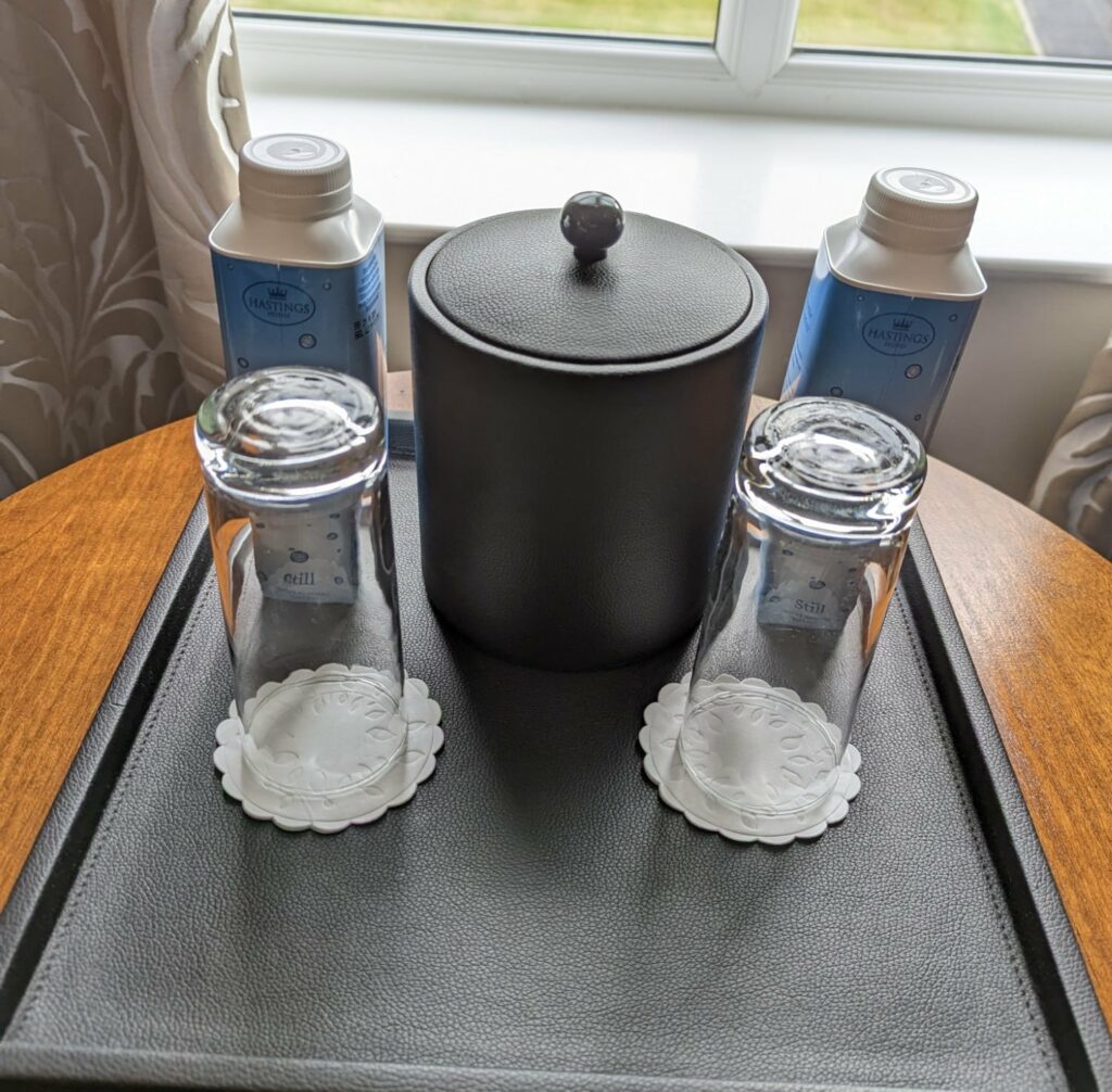 culloden estate and spa deluxe king room bottled water and glasses