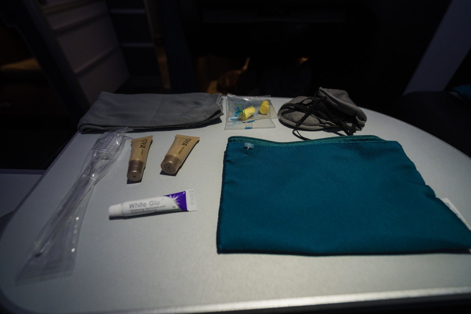 Amenity kit on Aer Lingus business class flight, including toothpaste, brush, socks, ear plugs, and a mask.
