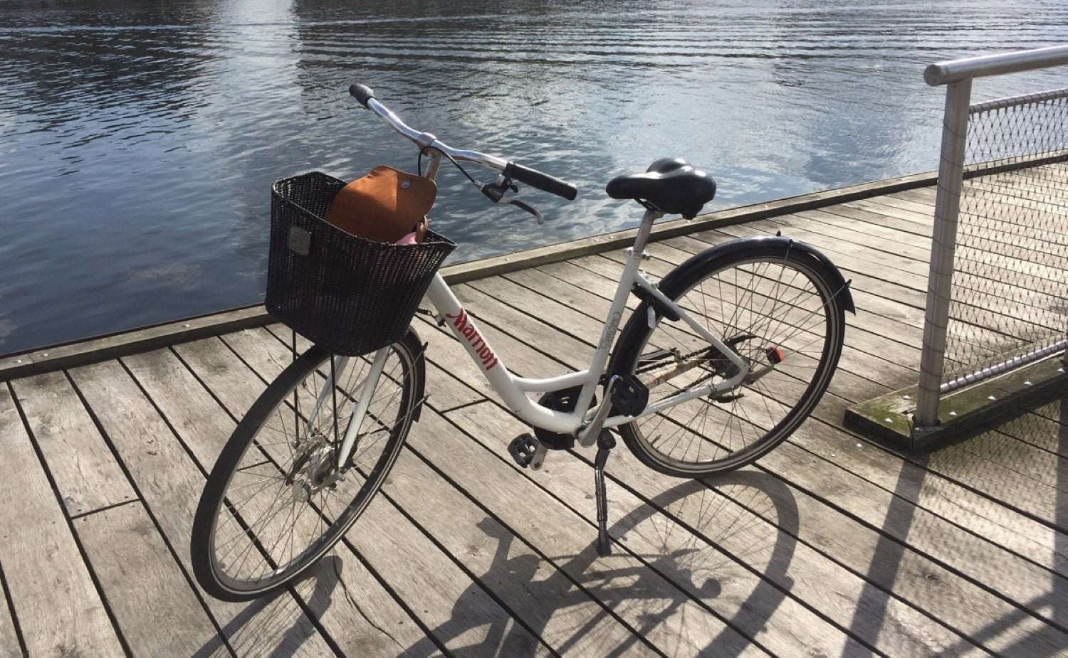 Marriott bicycle rental parked on a dock next to the Copenhagen canals.