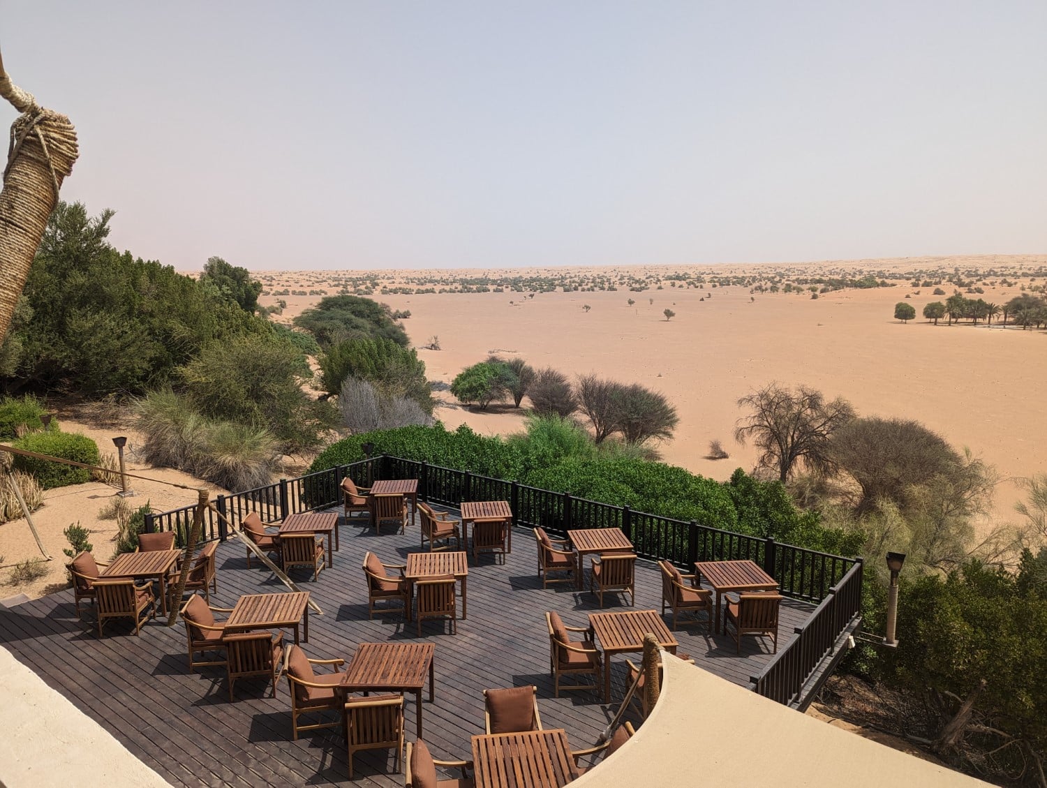 Outdoor patio seating overlooking the desert at Al Maha resort.
