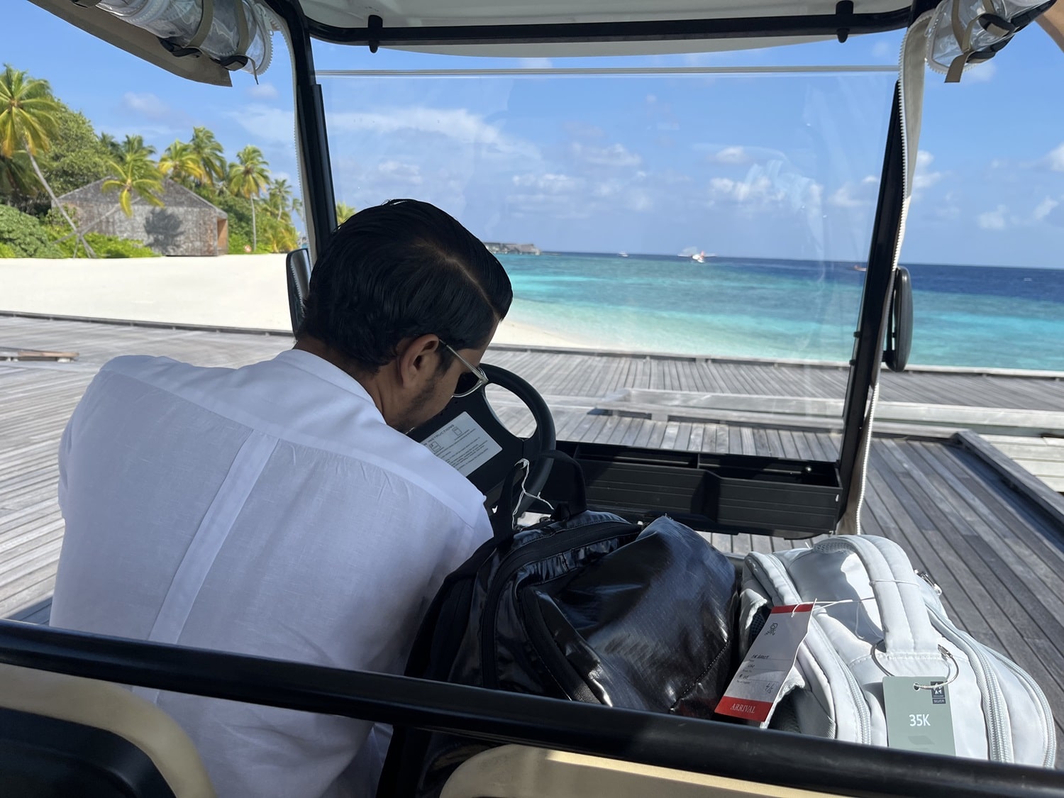 st regis maldives vommuli golf cart with butler