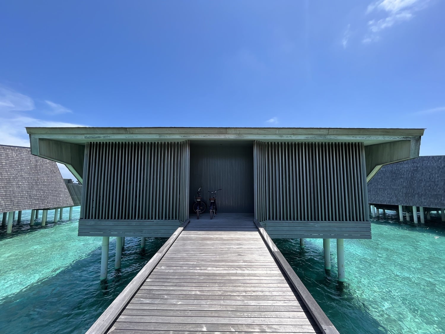 st regis maldives vommuli resort overwater bungalow exterior