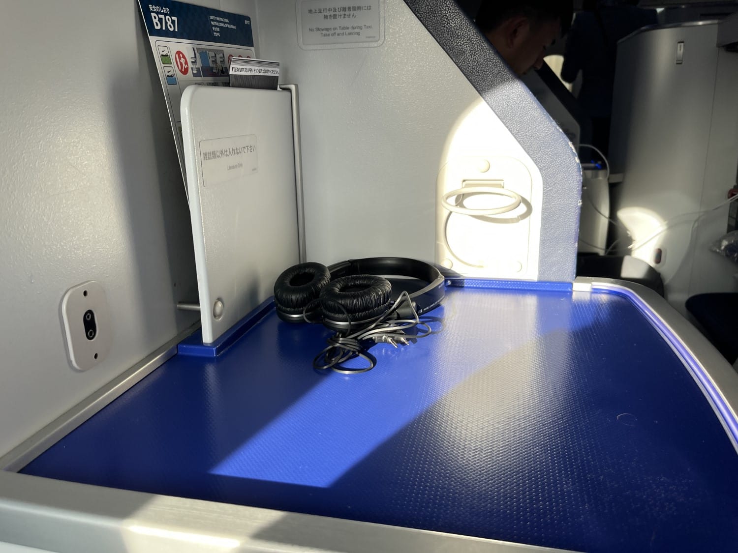 ana business class 787 storage table with headphones