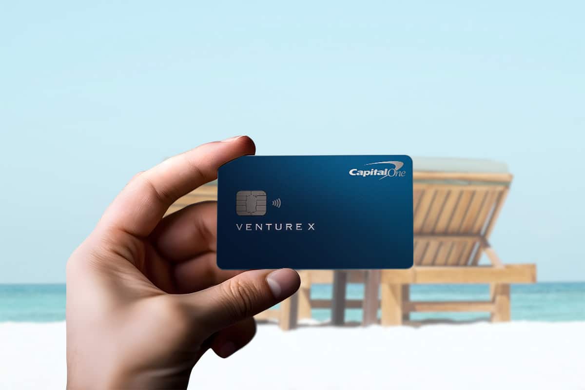 capital-one-venture-x-rewards-card-review-hand-holding-card-on-beach