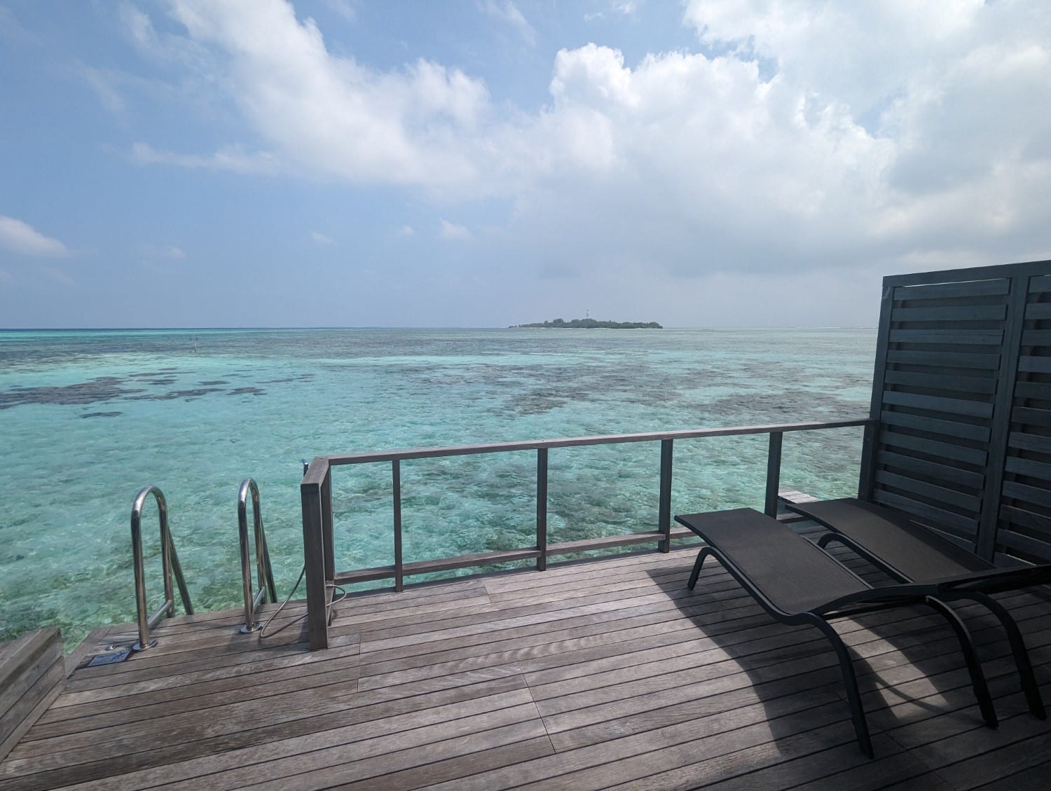 le meridien maldives resort sunrise overwater one bedroom villa balcony chairs