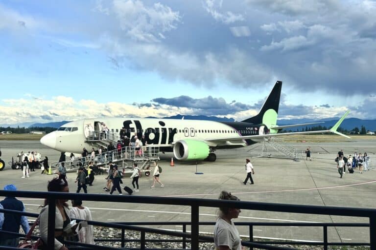 flair airlines airplane on tarmac with passengers disembarking