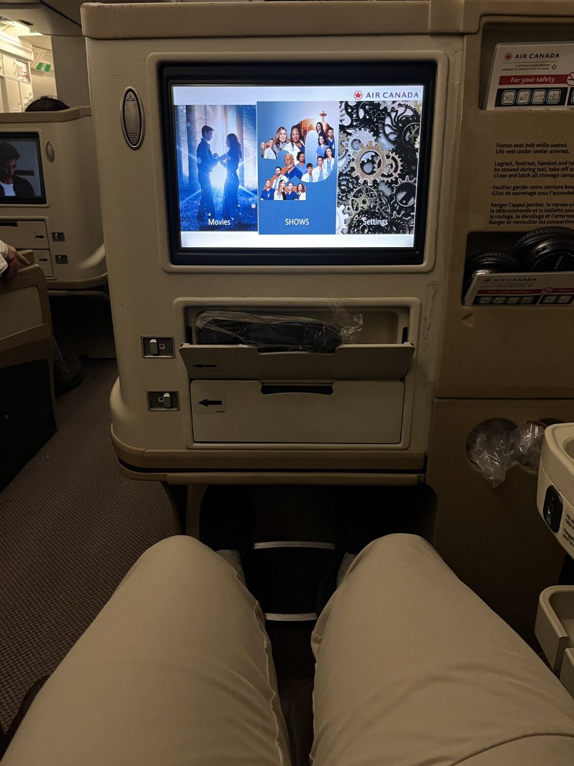 air canada a330 business class seat reclined with entertainment console screen