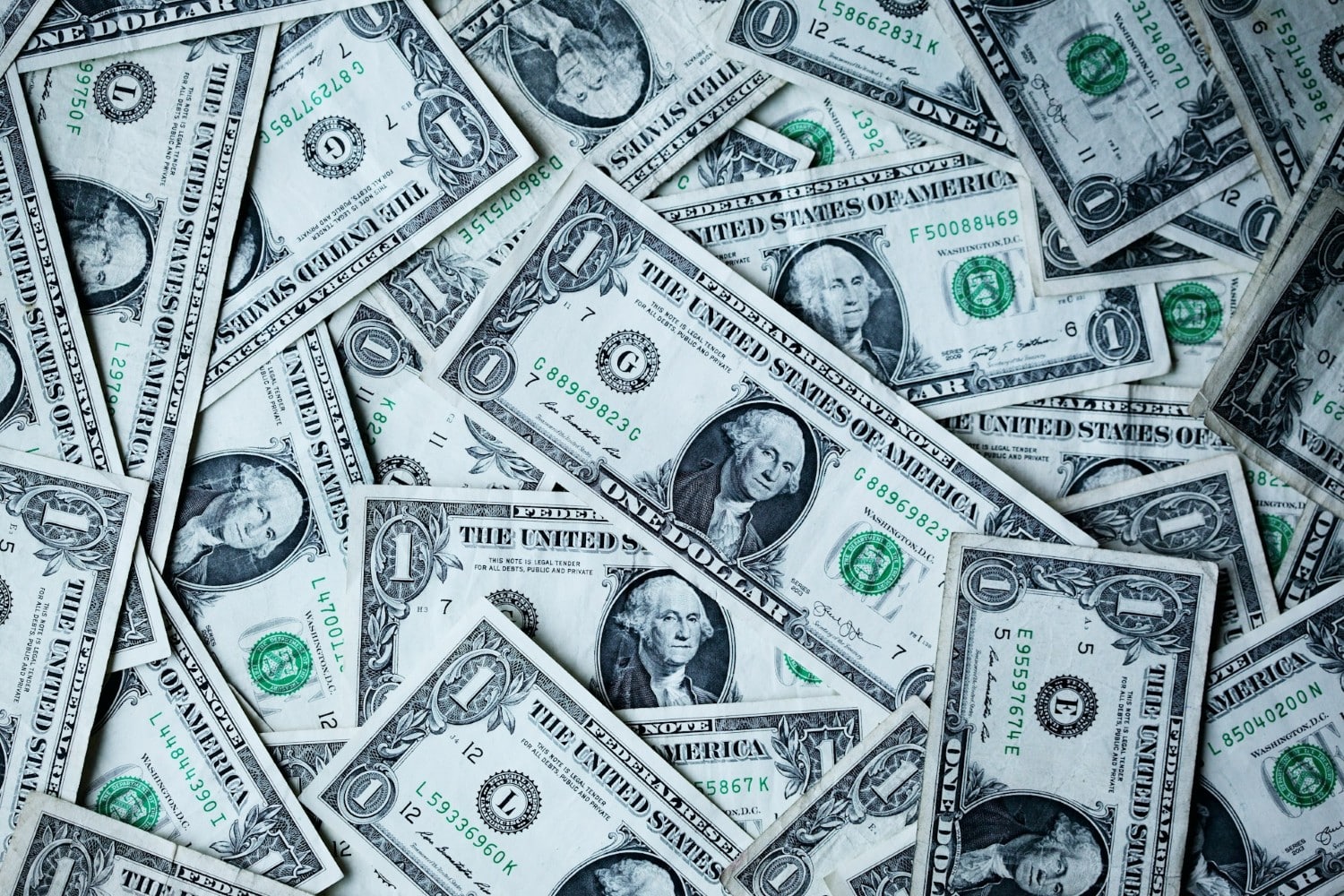 us dollars spread out on table