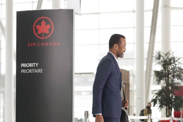 air-canada-priority-benefits-sign-guy-walking-featured