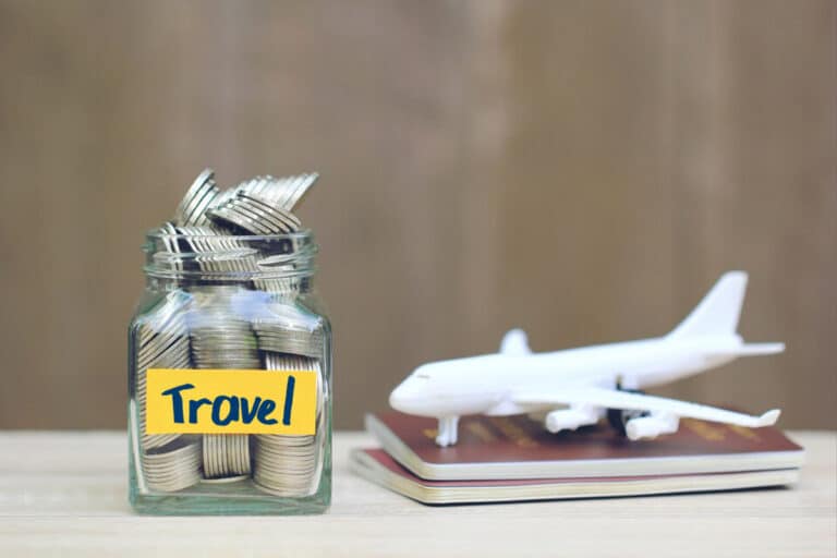 out-of-pocket-costs-of-award-travel-featured-travel-jar-coins-plane