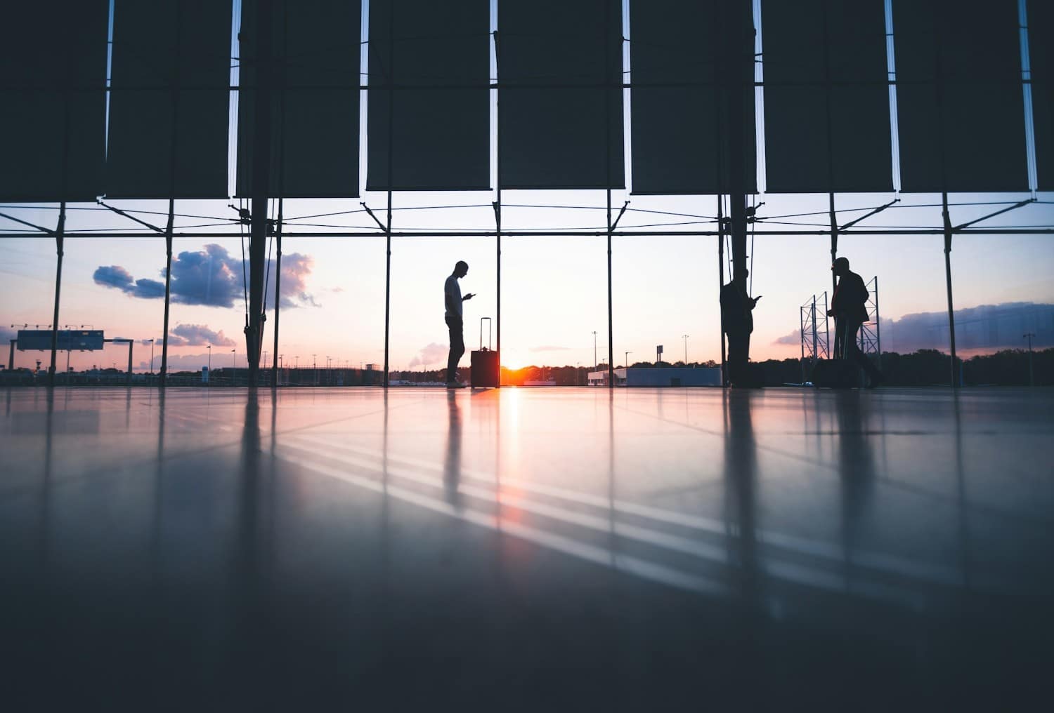 person standing in airport using cellphone
