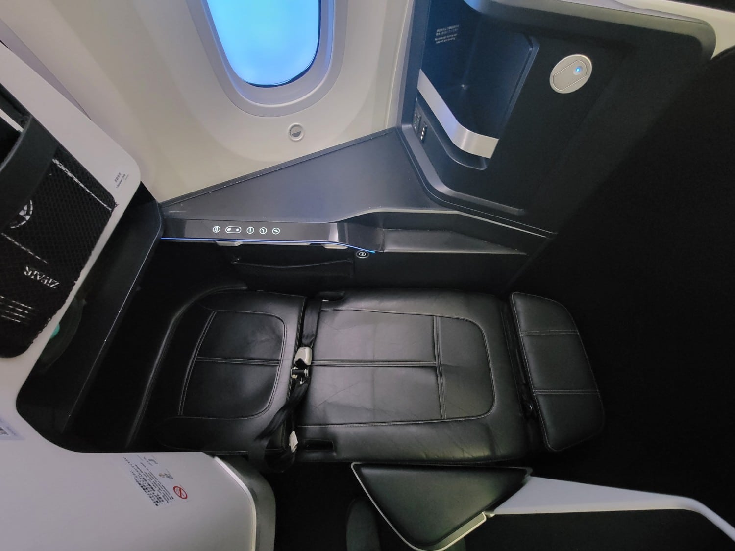 Zipair full flat business class seat in lie flat mode.