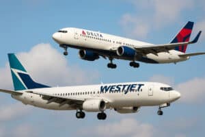 delta and westjet aircraft in flight