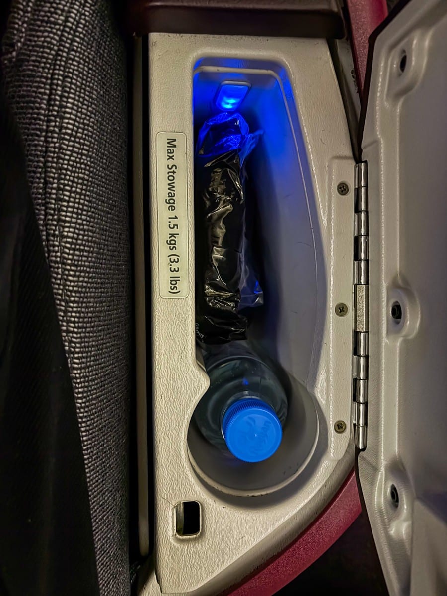 qatar airways business class 787-8 storage compartment with water