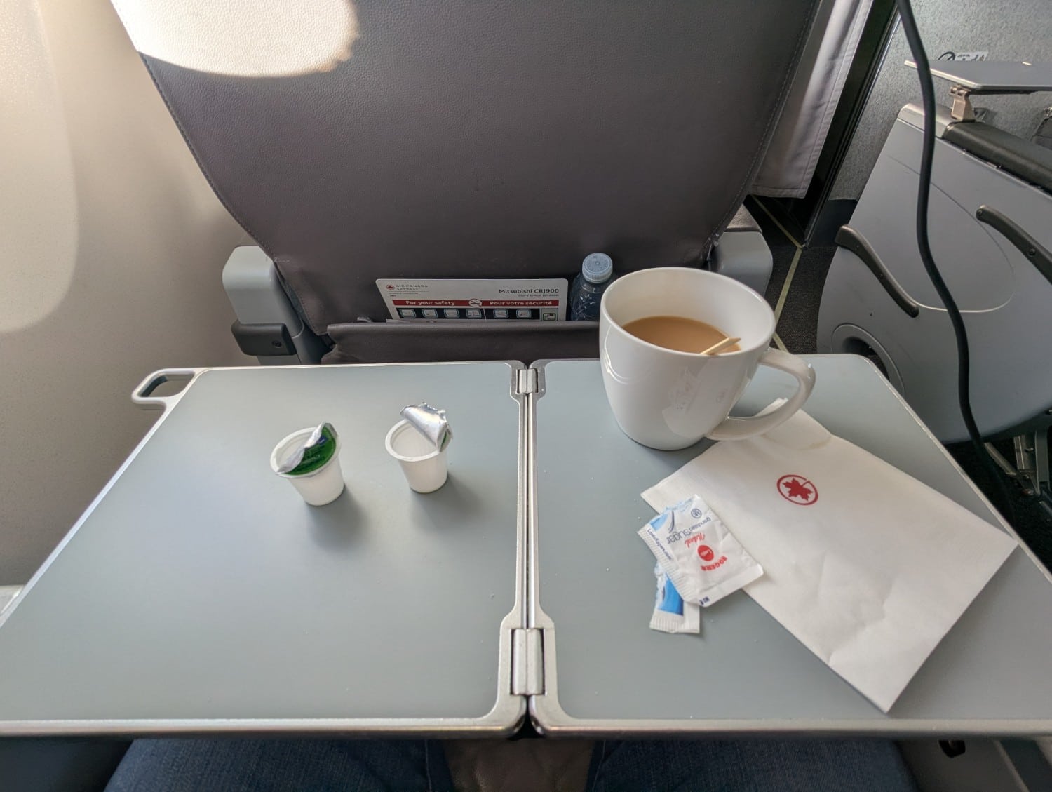 air canada express business class CRJ900 coffee on tray table