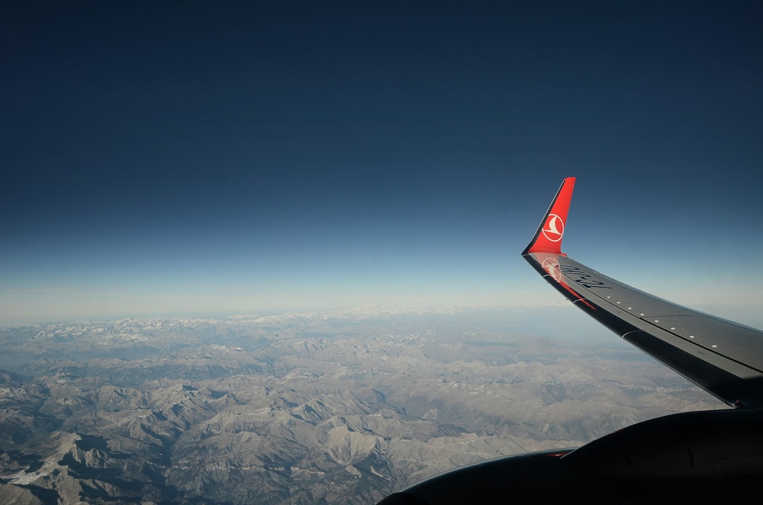 view of turkish airlines airplane wing mid-flight