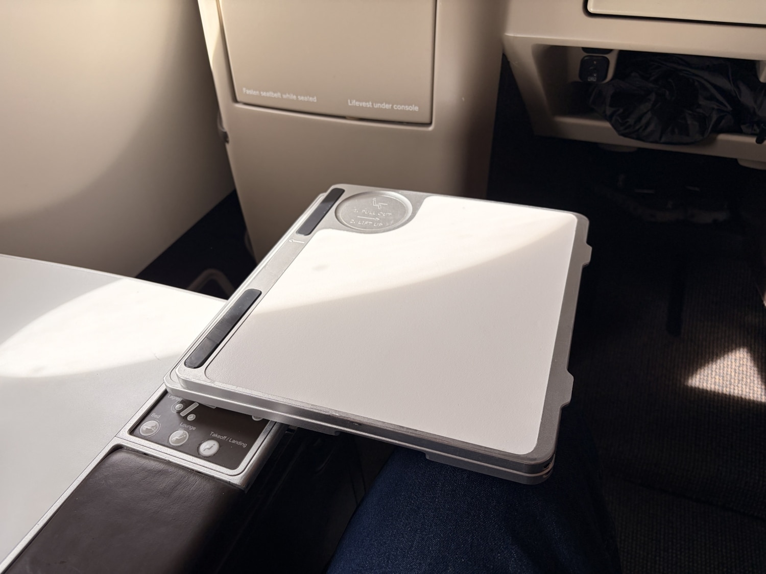 swiss business class a330 tray table partially extended above