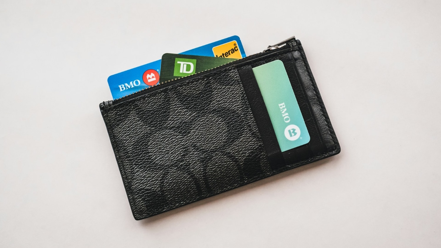 canadian credit and debit cards in black wallet
