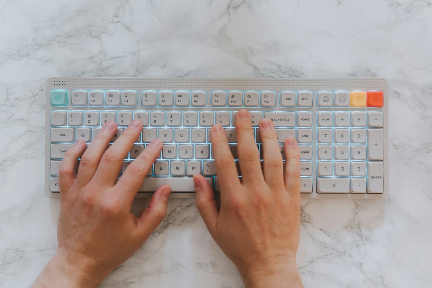 hands on keyboard on marble surface
