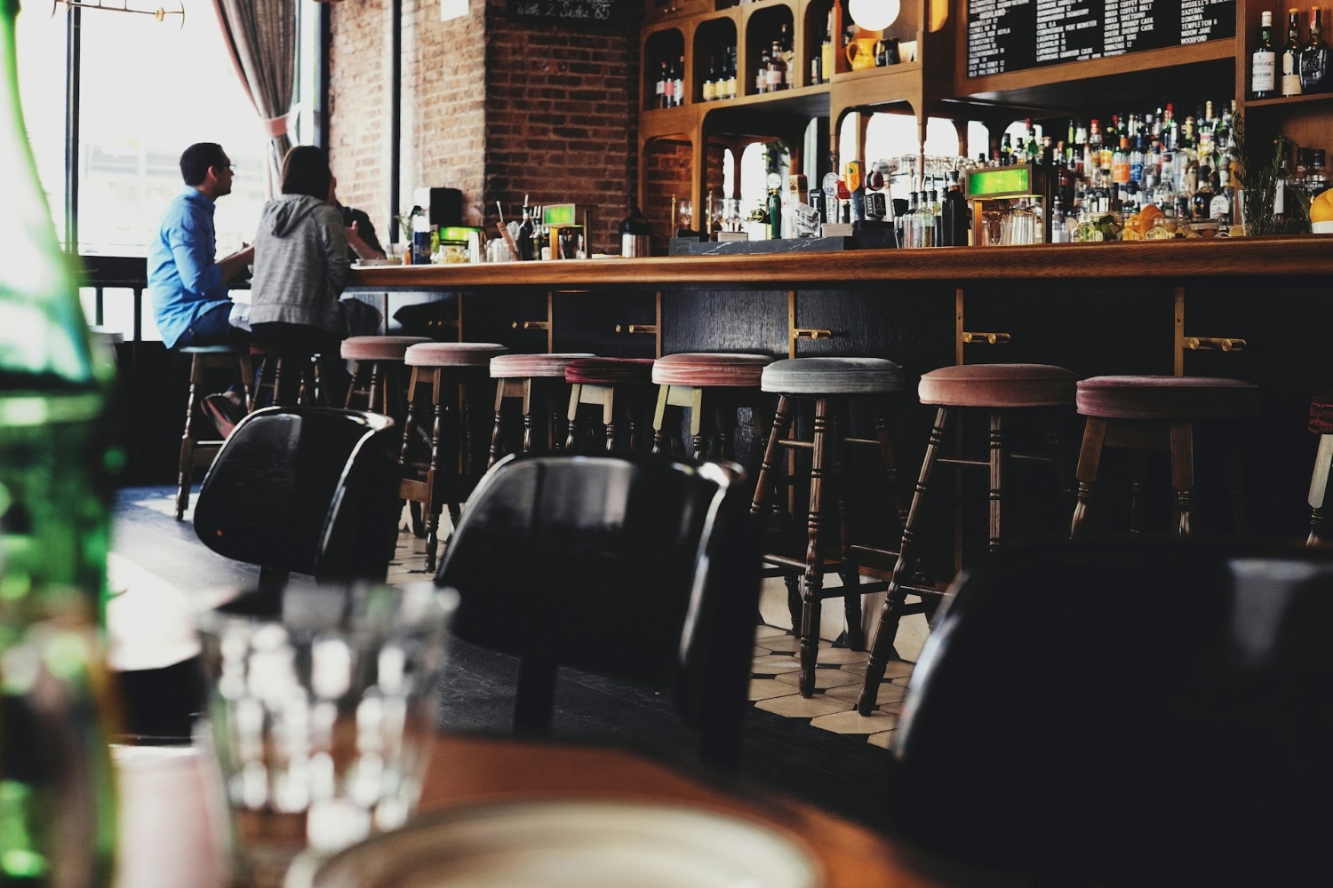 bar with customers seated on stools