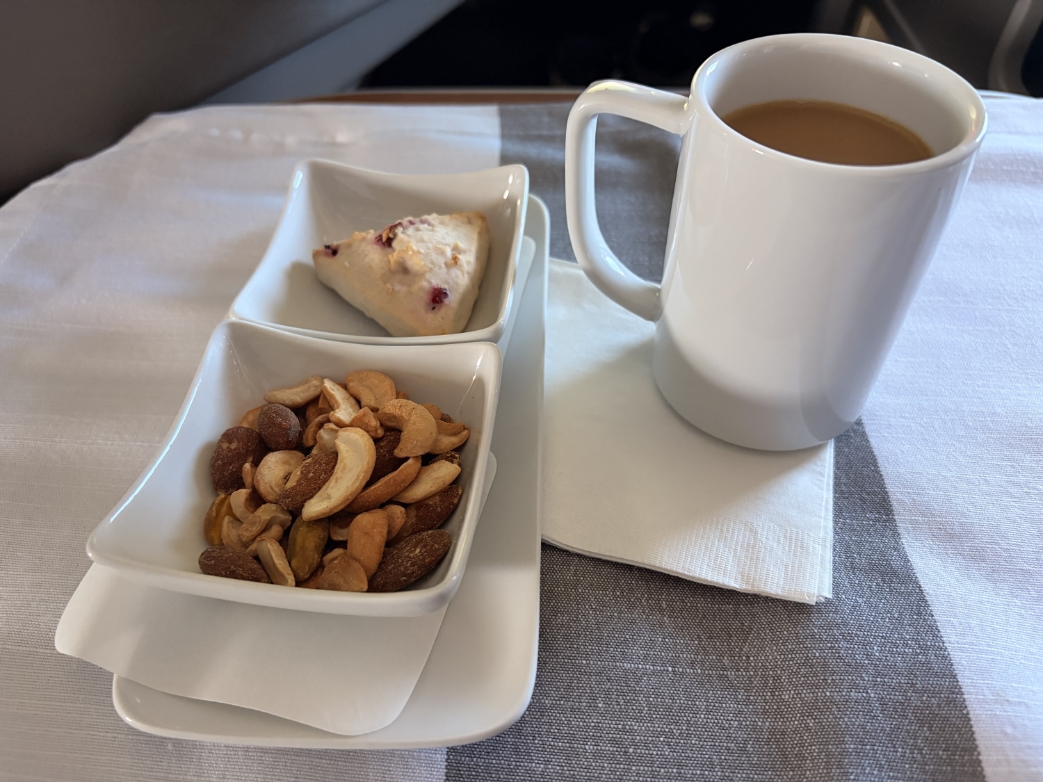 american airlines flagship first class nuts and scone with coffee