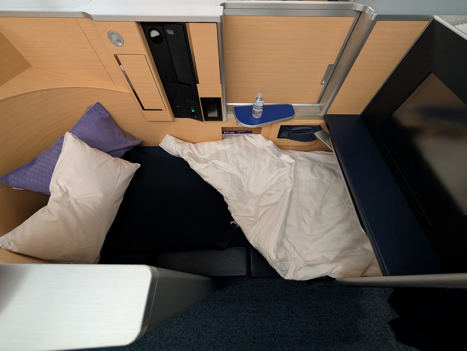 ana first class 777-300er lie-flat bed made with pillows and blankets