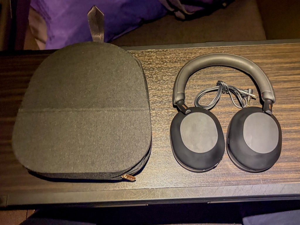 ana the suite first class headphones with case on tray table