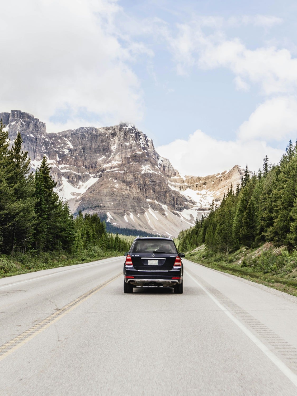 car on highway road with mountain in background