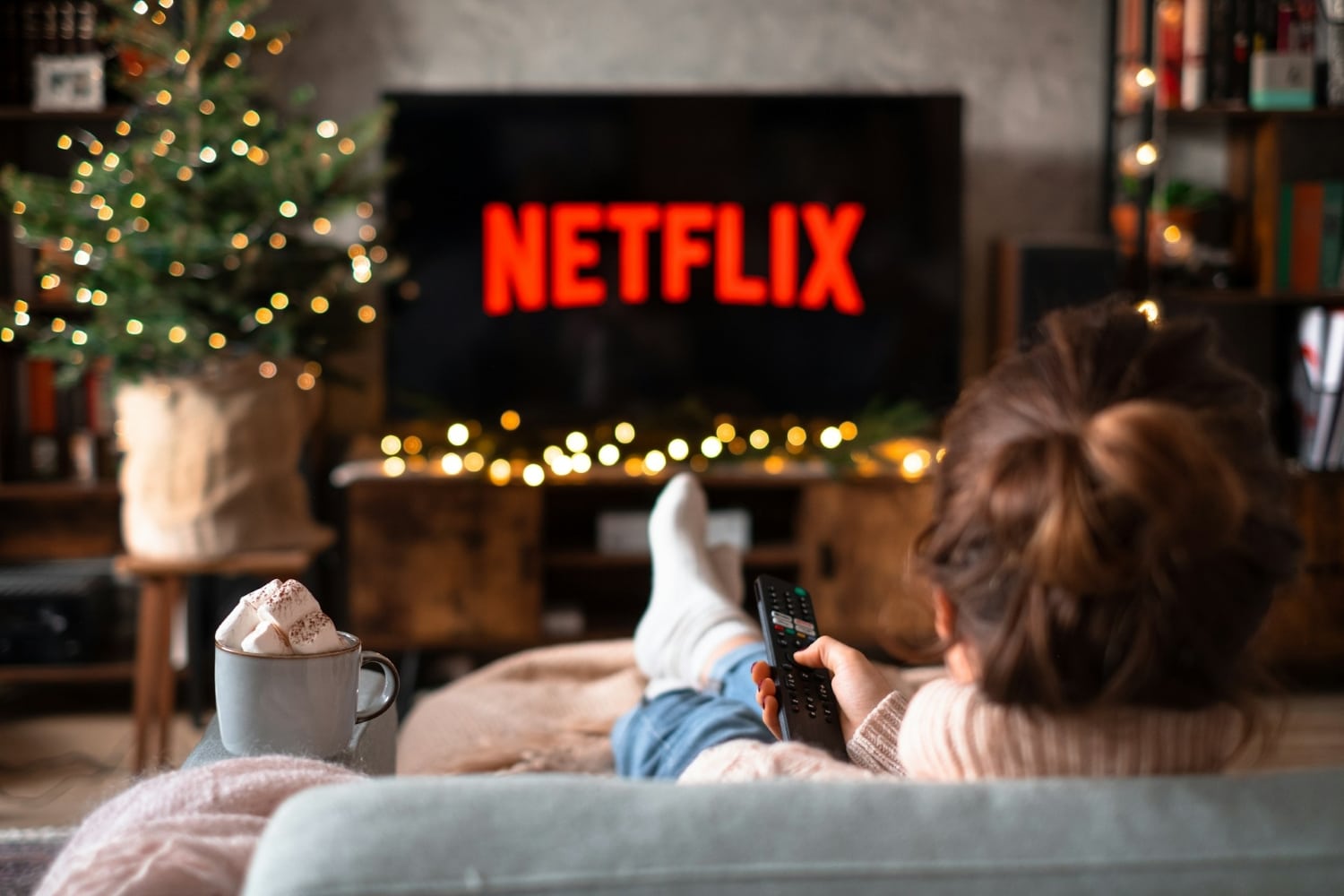 person watching netflix while lying on couch