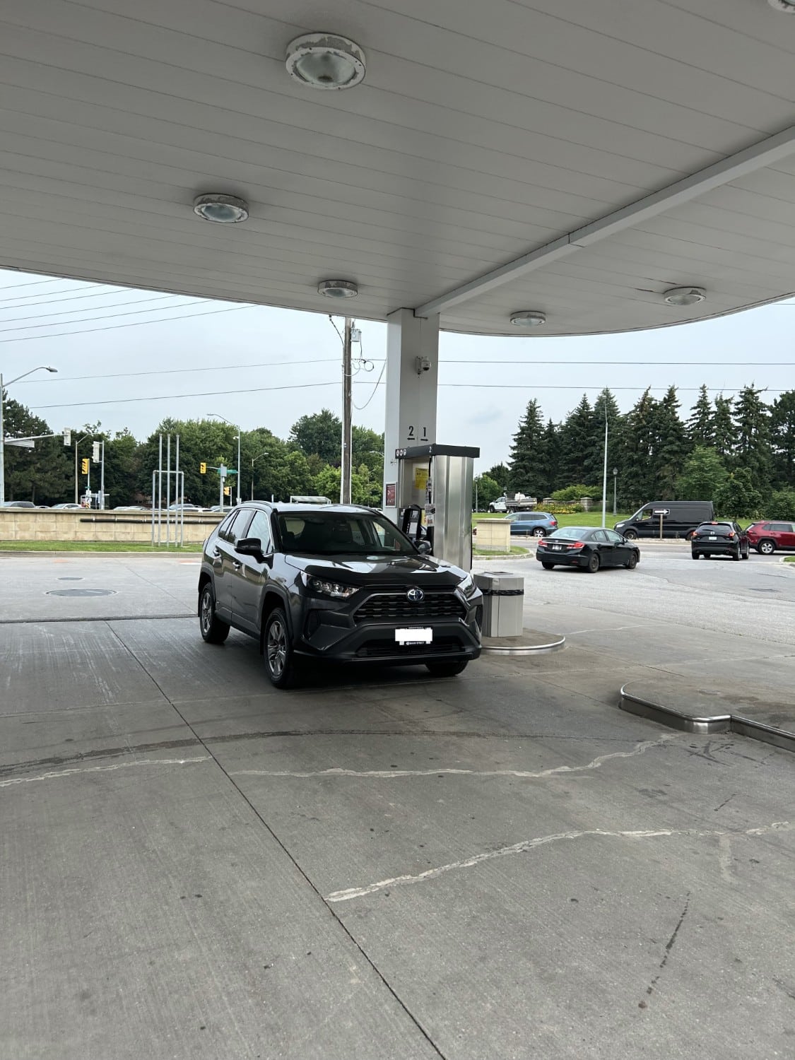 rental car parked as gas station filling up